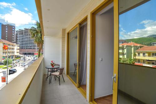 a balcony with a table and a view of a city at Victoria Center Apartments in Budva