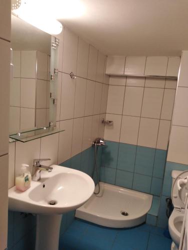 a bathroom with a sink and a toilet at Magic Ionian Apartments & Rooms in Himare