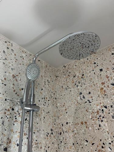 a shower with a shower head in a bathroom at Jays Bay Entire Luxury Apartment by the Beach Gt Yarmouth in Great Yarmouth