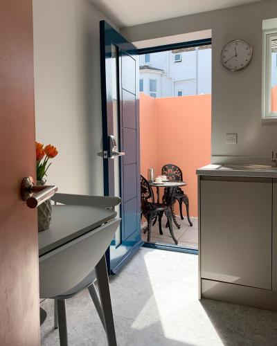 a kitchen with a door open to a dining room at Jays Bay Entire Luxury Apartment by the Beach Gt Yarmouth in Great Yarmouth