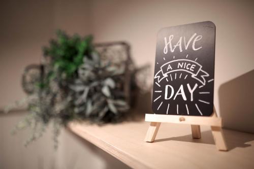 a chalkboard sign that says have a nice day at Stadtoase Kolping Hotel in Linz