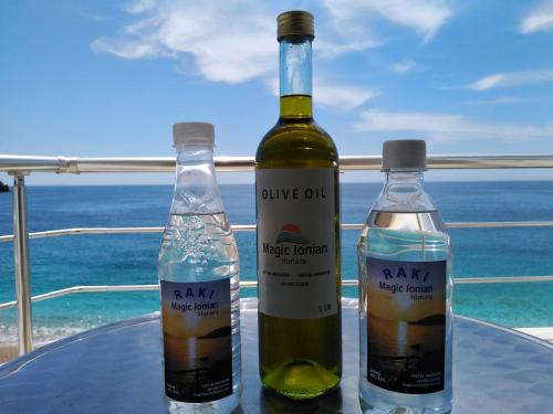 two bottles of wine sitting on top of a table at Magic Ionian Apartments & Rooms in Himare