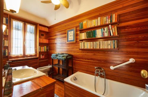 a bathroom with wooden walls and a tub and a sink at Ca' Fenice, charming apartment in San Marco, sleep 7 in Venice