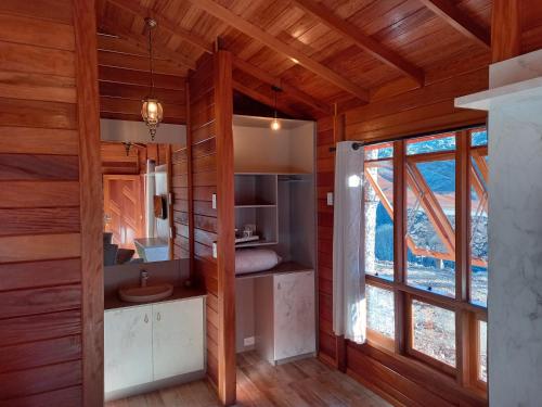 a room with a bathroom with a sink and a window at Cabanas do Empório Aparados da Serra in Bom Jardim da Serra