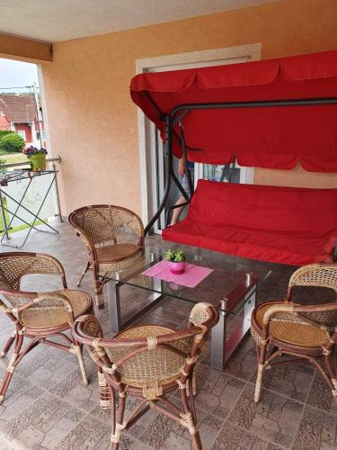 a patio with a bed and chairs and a table at Apartmani Apolon in Vrdnik