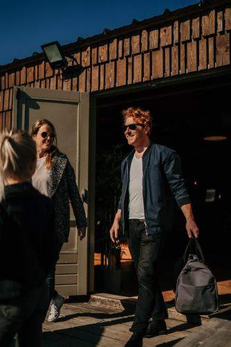 a man and a woman walking out of a building at Green Fields - Durbuy in Durbuy