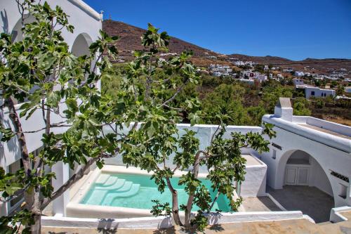 a villa with a swimming pool and a tree at Beachside Villa Agios Sostis in Agios Sostis