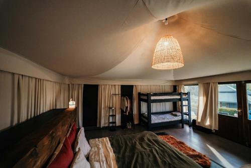 a bedroom with a large bed and a chandelier at Green Fields - Durbuy in Durbuy