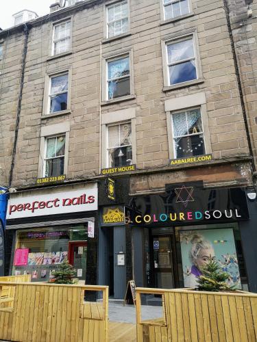 a store front of a brick building with windows at aabAlree Guest House in Dundee