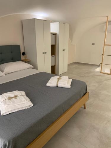 a bedroom with a bed with two towels on it at Madama B&B in Gaeta