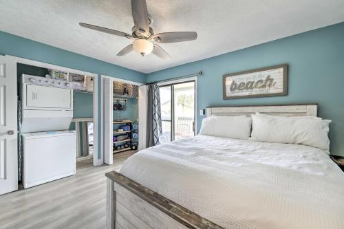 a bedroom with a bed and a ceiling fan at Panama City Condo w/ Balcony & Pool, Walk to Beach in Panama City Beach