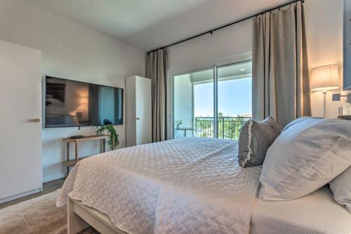 a bedroom with a large bed and a balcony at Ocean View Condo Btwn Rosemary and Alys Beach! in Rosemary Beach