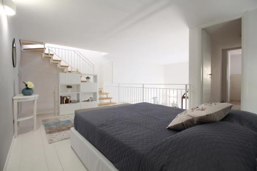 a bedroom with a bed and a staircase at Loft 92 in San Vito lo Capo