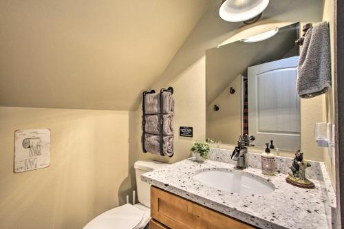 a bathroom with a sink and a toilet at Cozy Cabin - 5 Miles to Mt Rainier National Park! in Ashford