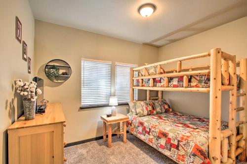 a bedroom with a bunk bed and a bed and a desk at Cozy Cabin - 5 Miles to Mt Rainier National Park! in Ashford