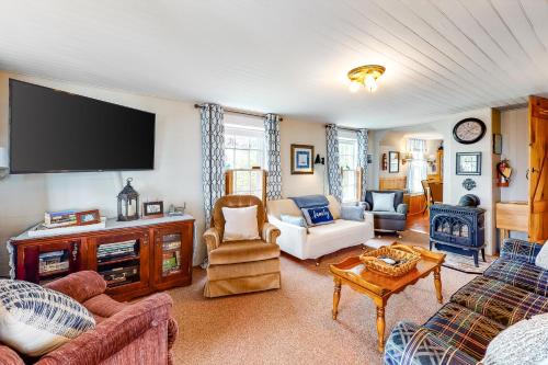 a living room with a flat screen tv on the wall at Best View in ME in East Boothbay