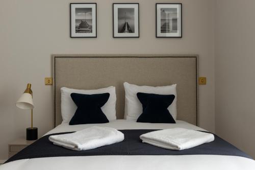 a bedroom with a bed with two pillows at The Burlington in Worthing
