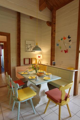 a dining room with a table and chairs at Charmant Chalet LE DAMELI, Village du Soleil, Chalet 61 in Mauroux