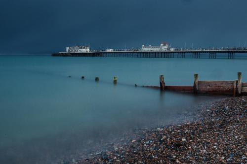 a large body of water with a pier in the background at The Burlington in Worthing