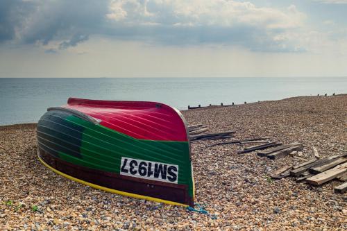 a boat sitting on top of a beach at The Burlington in Worthing