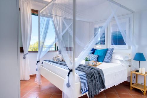 a bedroom with a bed with a canopy at Borgo Eleatico in Casal Velino