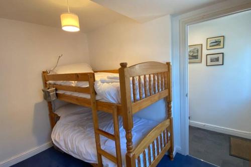 a couple of bunk beds in a room at Poet's Corner - flat close to centre of Keswick in Keswick