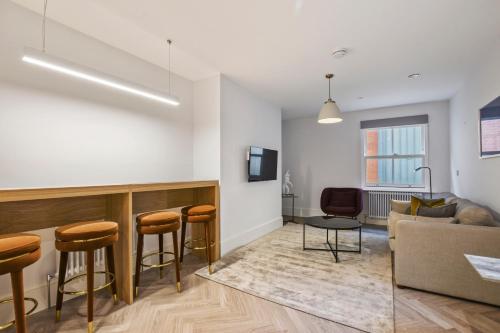 a living room with a couch and a table at Victoria House by Aeria Apartments in Reading