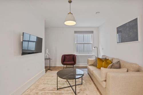 a living room with a couch and a table at Victoria House by Aeria Apartments in Reading