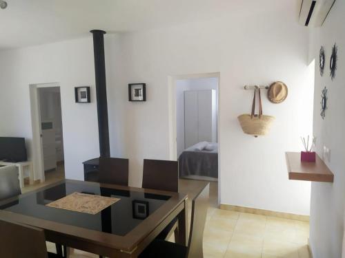 a living room with a stove and a table at Hermosa casa con piscina cerca de la playa de Punta Prima in Punta Prima