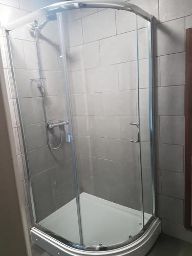 a shower with a glass door in a bathroom at The Vaults in Wrexham