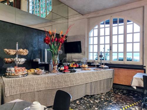 a long table with food on it in a room at Hotel Castello S. Antonio in Lazise