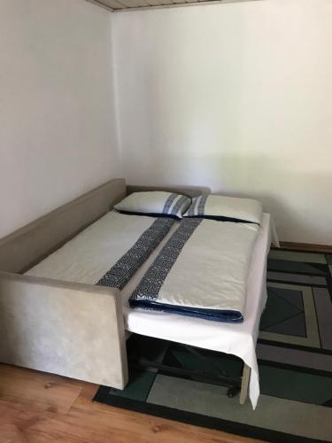 a bed sitting in a corner of a room at Hava 2 in Sarajevo