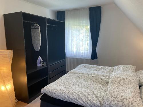 a bedroom with a bed and a window at Gemütliche Dachgeschosswohnung in Aßlar