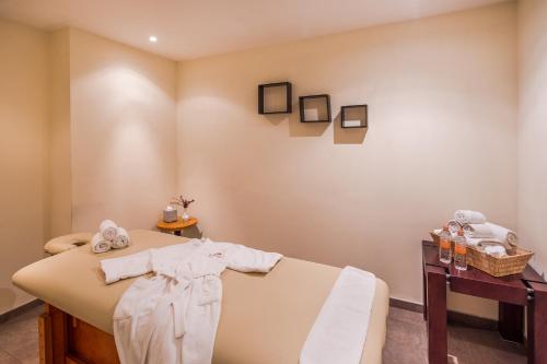 a room with a bed with towels on it at Crowne Plaza Monterrey Aeropuerto by IHG in Monterrey