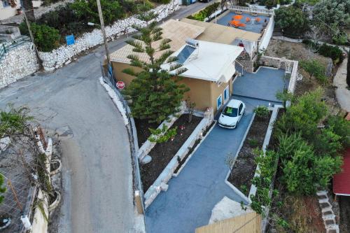 a white car parked in front of a house at Villa IRENE in Zóla
