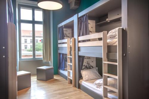 a room with bunk beds in it with a window at The People - Strasbourg in Strasbourg
