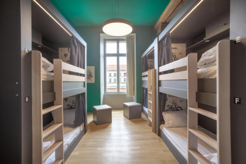 a room with multiple bunk beds with a window at The People - Strasbourg in Strasbourg