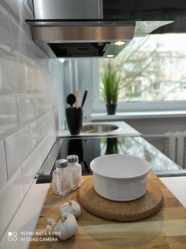 a kitchen counter with a bowl on a cutting board at Hiiumaa Family Apartments in Kärdla