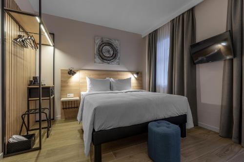 a hotel room with a large bed and a television at KONTRAKT Boutique Hotel in Kyiv