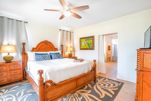 a bedroom with a bed and a ceiling fan at Plantations at Princeville #512 in Princeville