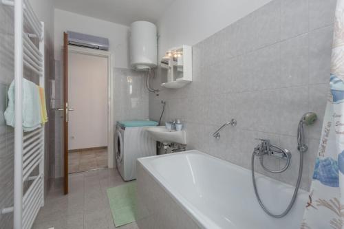 a bathroom with a bath tub and a sink at Holiday Home with pool in Višnjan in Farini