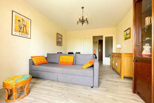 - un salon avec un canapé gris et des oreillers orange dans l'établissement Superb Apartment With Balcony In Frejus, à Fréjus