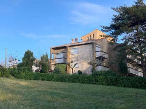 a large house with a grassy field in front of it at Résidence Les Milandes in Cazaubon