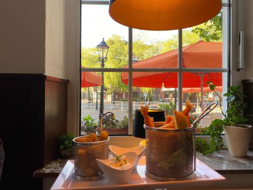 a table with two buckets of carrots and a window at MediTerra in Papenburg