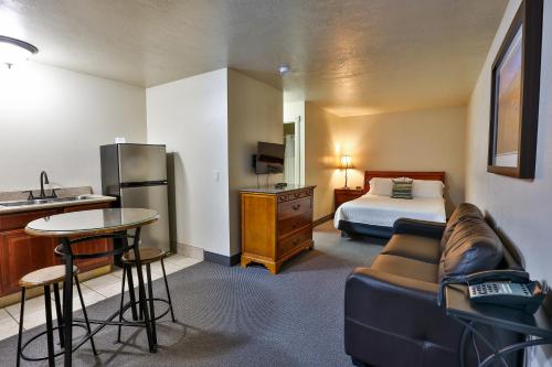 a hotel room with a couch and a bed at The Chalet in St. George