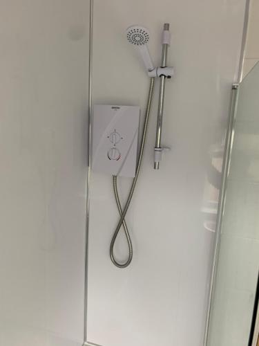 a shower with a shower head on a wall at Beautiful house in a perfect location in Saint Annes on the Sea