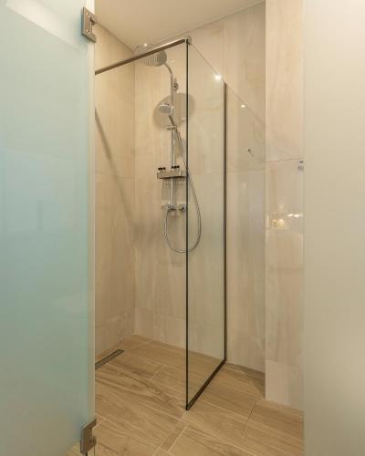 a shower with a glass door in a bathroom at KONTRAKT Boutique Hotel in Kyiv
