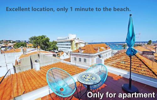 a balcony with two chairs and a view of the ocean at Kasa 23 Cascais - Boutique Guest House in Cascais