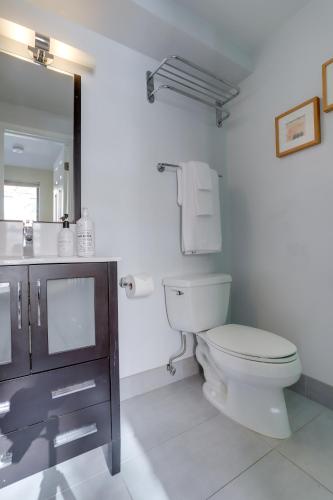 a bathroom with a toilet and a sink and a mirror at Sojourn at DuPont Place in Washington