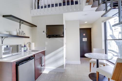 a kitchen with a staircase and a dining room at Sojourn at DuPont Place in Washington